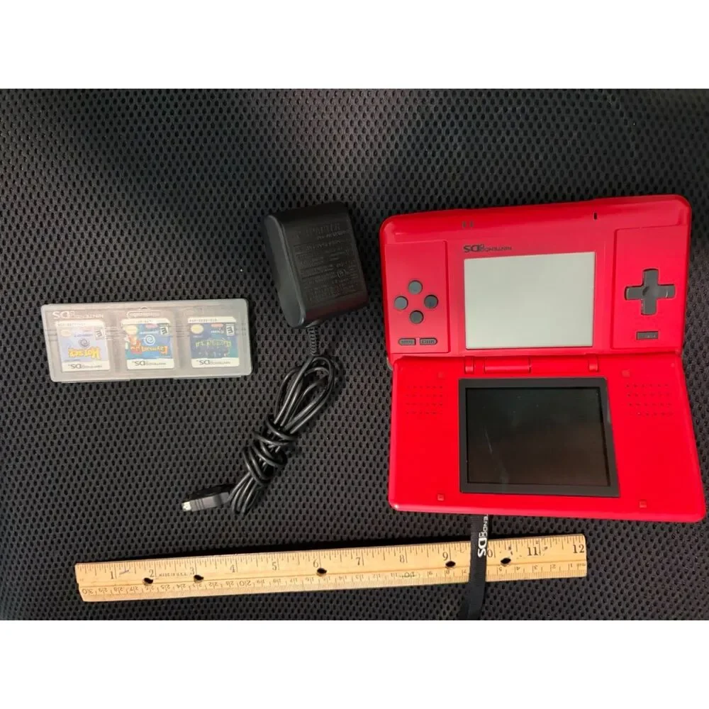 Red nintendo DS with charger and 3 games gently used